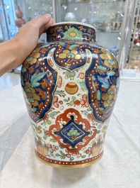 A Chinese English-decorated blue and white vase and cover, Kangxi