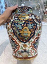 A Chinese English-decorated blue and white vase and cover, Kangxi