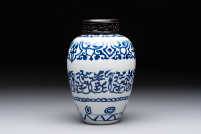 Three Chinese blue and white vases, one with wooden cover, Kangxi
