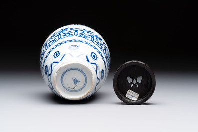 Three Chinese blue and white vases, one with wooden cover, Kangxi