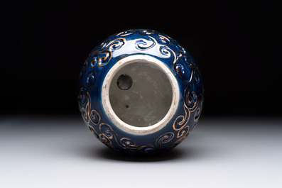 A Japanese Kutani group of a Shishi standing on an openworked brocade ball, 20th C.