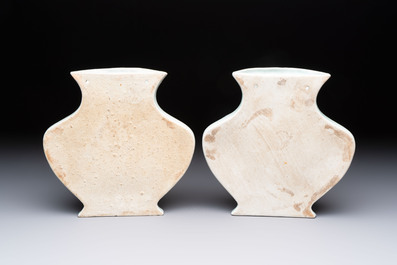 A pair of Chinese blue and white celadon-ground 'Buddhist lions' wall pocket vases, Yongzheng mark, 19/20th C.