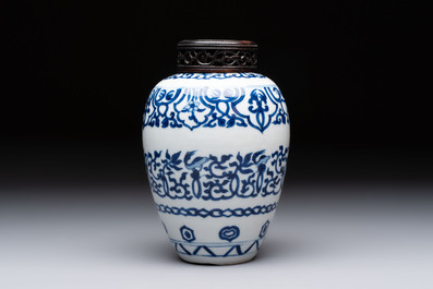 Three Chinese blue and white vases, one with wooden cover, Kangxi