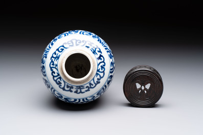 Three Chinese blue and white vases, one with wooden cover, Kangxi