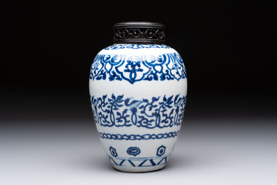 Three Chinese blue and white vases, one with wooden cover, Kangxi