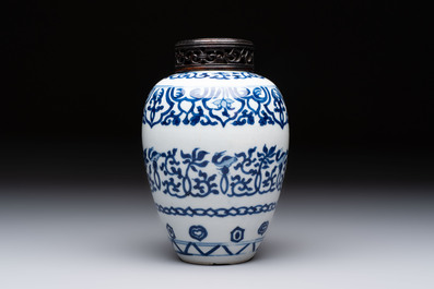 Three Chinese blue and white vases, one with wooden cover, Kangxi