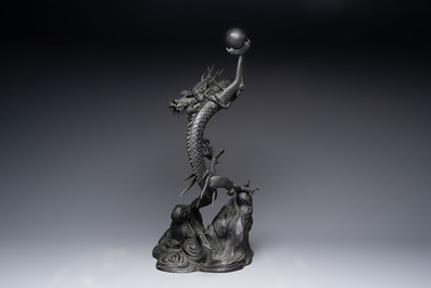 A large Japanese bronze dragon holding a pearl, Meiji, 19th C.