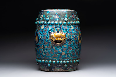 A Chinese Fahua barrel-shaped 'lotus scroll' stool with incised design, Ming