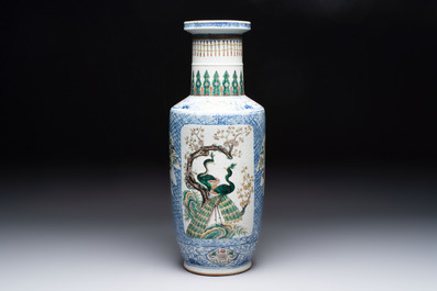 A Chinese blue, white and famille verte rouleau vase with figural and peacock design, Qianlong mark, 19th C.