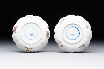 A pair of Chinese famille verte cups and saucers with antiquities, Kangxi