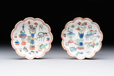 A pair of Chinese famille verte cups and saucers with antiquities, Kangxi