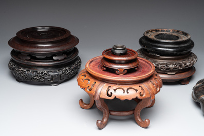 A collection of 11 Chinese wooden stands, 19/20th C.