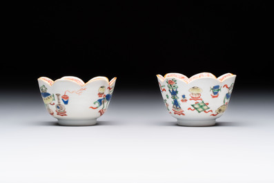 A pair of Chinese famille verte cups and saucers with antiquities, Kangxi