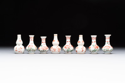 Eight Chinese wucai and gilt-iron-red miniature vases with floral design, Kangxi
