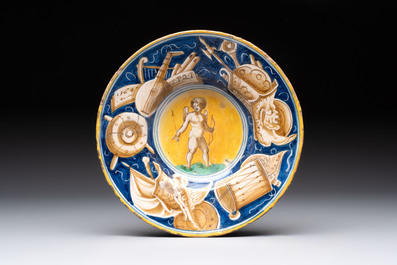A polychrome Italian maiolica plate with Cupid holding an arrow, Casteldurante, dated 1560