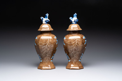A rare pair of blue and white Dutch Delft brown-ground vases and covers, 18th C.