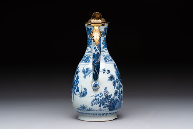 A fine blue and white Dutch Delft chinoiserie jug with brass lid, 17th C.