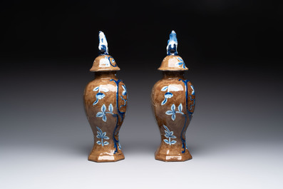 A rare pair of blue and white Dutch Delft brown-ground vases and covers, 18th C.