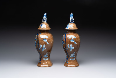 A rare pair of blue and white Dutch Delft brown-ground vases and covers, 18th C.