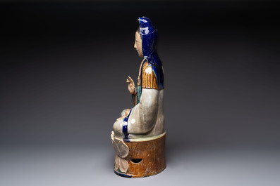 A large Chinese polychrome-glazed Shiwan stoneware figure of Guanyin, 19th C.
