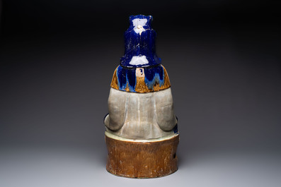 A large Chinese polychrome-glazed Shiwan stoneware figure of Guanyin, 19th C.
