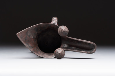 A Chinese archaic bronze wine vessel with Taotie design, 'Jue 爵', Zhou