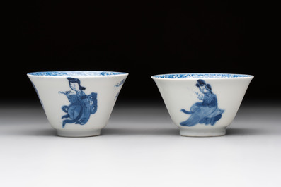 A pair of Chinese blue and white 'elegant beauty and boy' cups and saucers, Chenghua mark, Kangxi