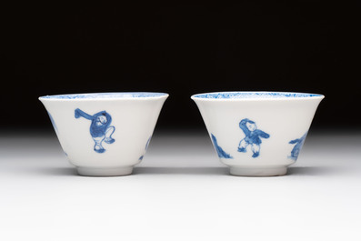 A pair of Chinese blue and white 'Elegant Beauty and Boy' cups and saucers, Chenghua mark, Kangxi