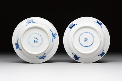 A pair of Chinese blue and white 'Elegant Beauty and Boy' cups and saucers, Chenghua mark, Kangxi
