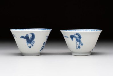 A pair of Chinese blue and white 'elegant beauty and boy' cups and saucers, Chenghua mark, Kangxi