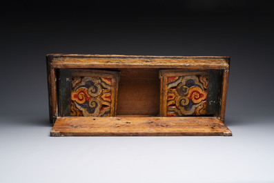 Two Tibetan polychromed wooden folding tables with dragon design, 19/20th C.