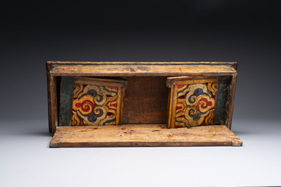 Two Tibetan polychromed wooden folding tables with dragon design, 19/20th C.
