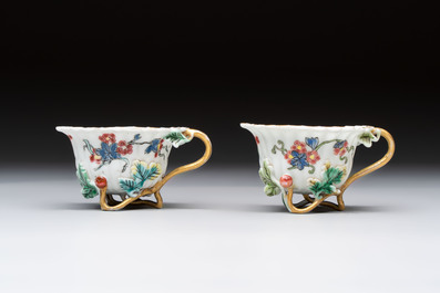 Two Chinese gilt-decorated famille rose cups and saucers with floral design, Qianlong