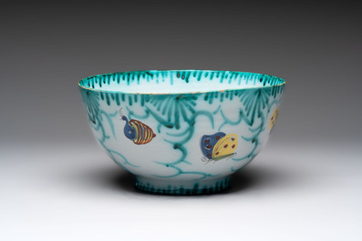 A large polychrome Brussels faience bowl and stand with butterfly and peacock design, 18th C.
