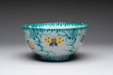 A large polychrome Brussels faience bowl and stand with butterfly and peacock design, 18th C.