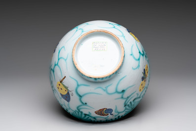A large polychrome Brussels faience bowl and stand with butterfly and peacock design, 18th C.