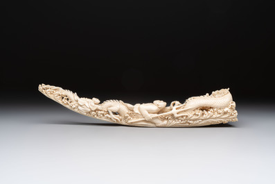 A Chinese ivory carving depicting a Luohan and a dragon, 'Da Ming 大明' mark, 19/20th C.