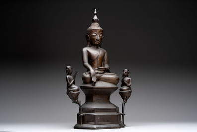 A large and fine Burmese bronze Buddha with two servants, 16/17th C.