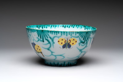 A large polychrome Brussels faience bowl and stand with butterfly and peacock design, 18th C.
