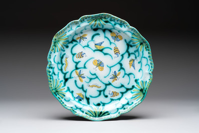 A large polychrome Brussels faience bowl and stand with butterfly and peacock design, 18th C.