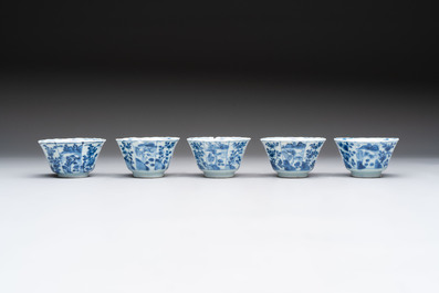 A set of 11 Chinese blue and white cups and saucers with riverscape design, Kangxi