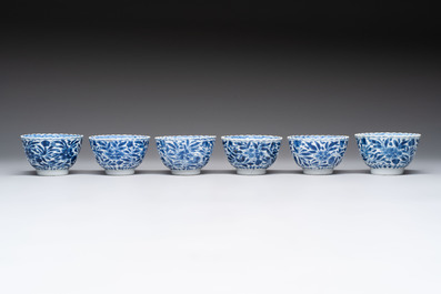 A set of six Chinese blue and white cups and saucers with floral design, Kangxi