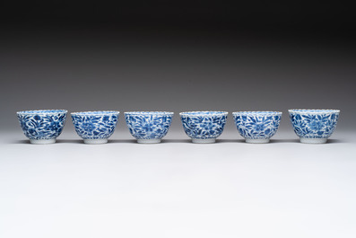 A set of six Chinese blue and white cups and saucers with floral design, Kangxi
