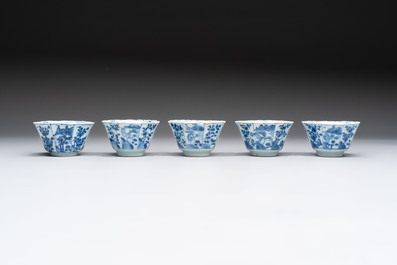 A set of 11 Chinese blue and white cups and saucers with riverscape design, Kangxi