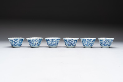 A set of 11 Chinese blue and white cups and saucers with riverscape design, Kangxi
