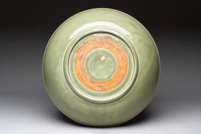 A rare and large Chinese Longquan celadon 'lotus bouquet' dish, Ming, early 15th C.