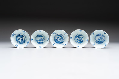A set of 11 Chinese blue and white cups and saucers with riverscape design, Kangxi