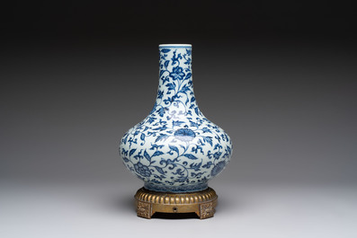 A gilt-bronze-mounted Chinese blue and white bottle vase with floral design, 19/20th C.