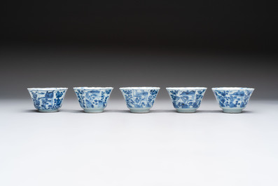 A set of 11 Chinese blue and white cups and saucers with riverscape design, Kangxi