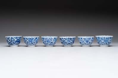 A set of six Chinese blue and white cups and saucers with floral design, Kangxi